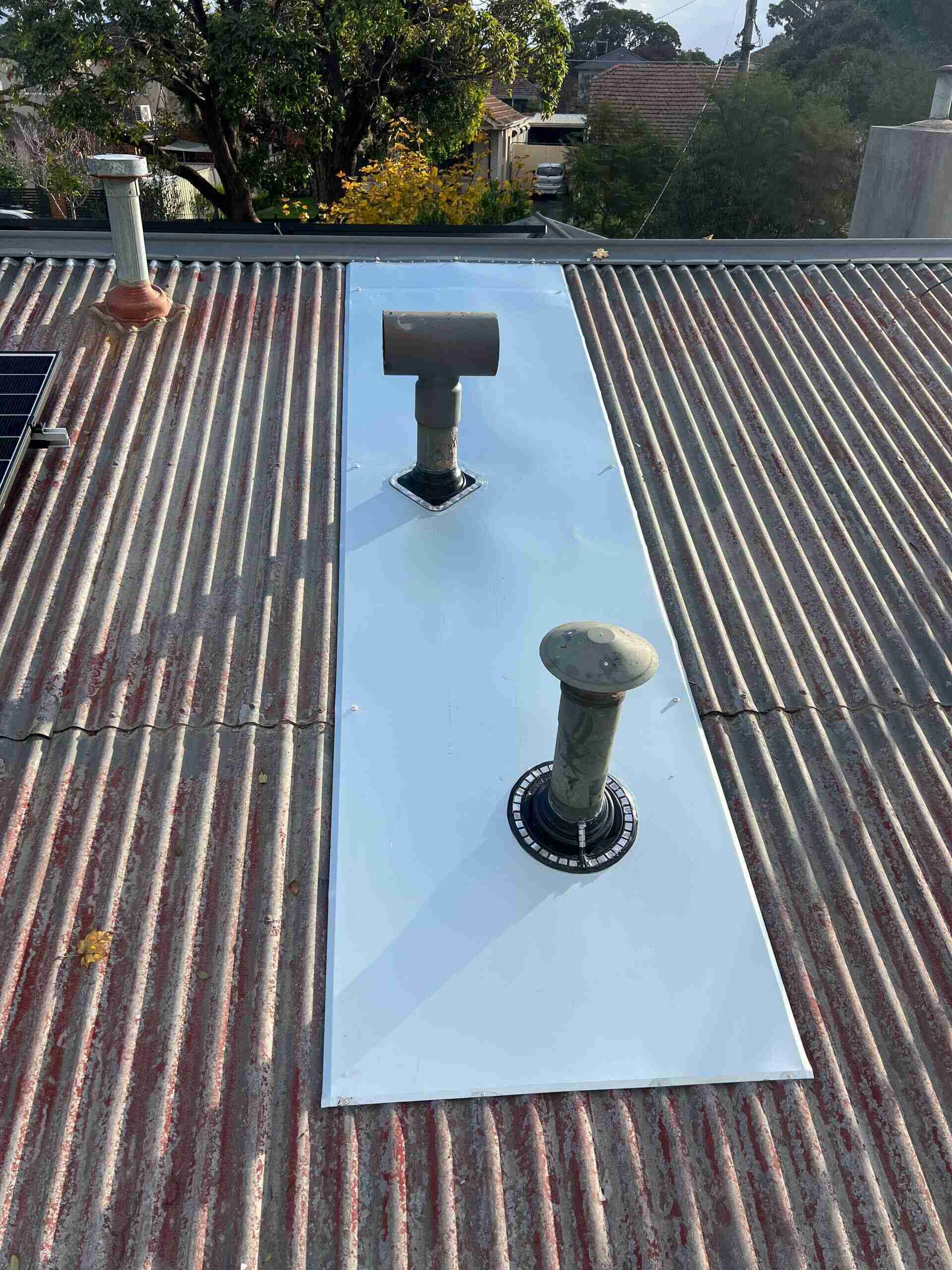 Close-up of dry pan flashing system with tiles seated in metal pans along wall line